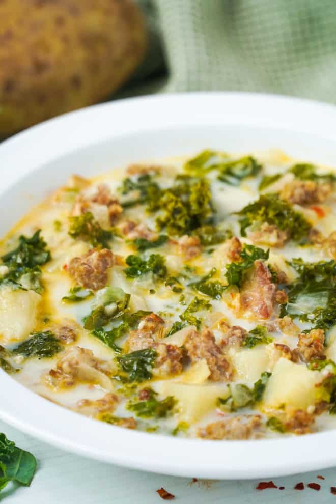 bowl full of a creamy sausage and kale soup