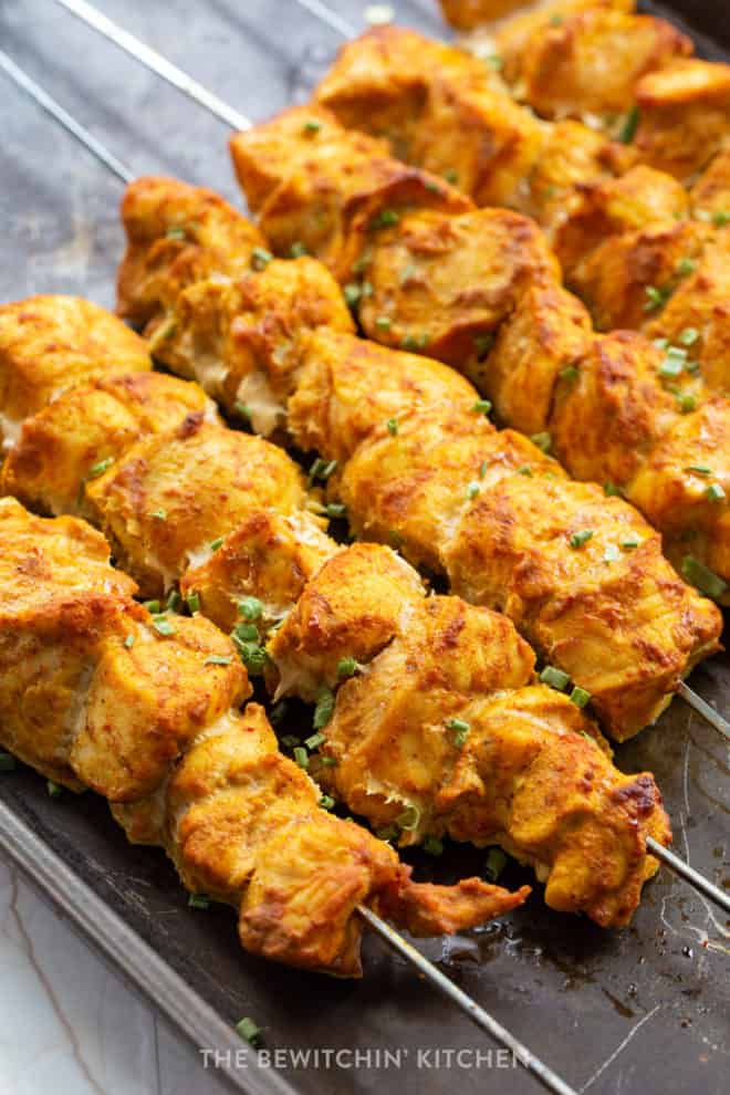 baked chicken kebabs on a baking sheet