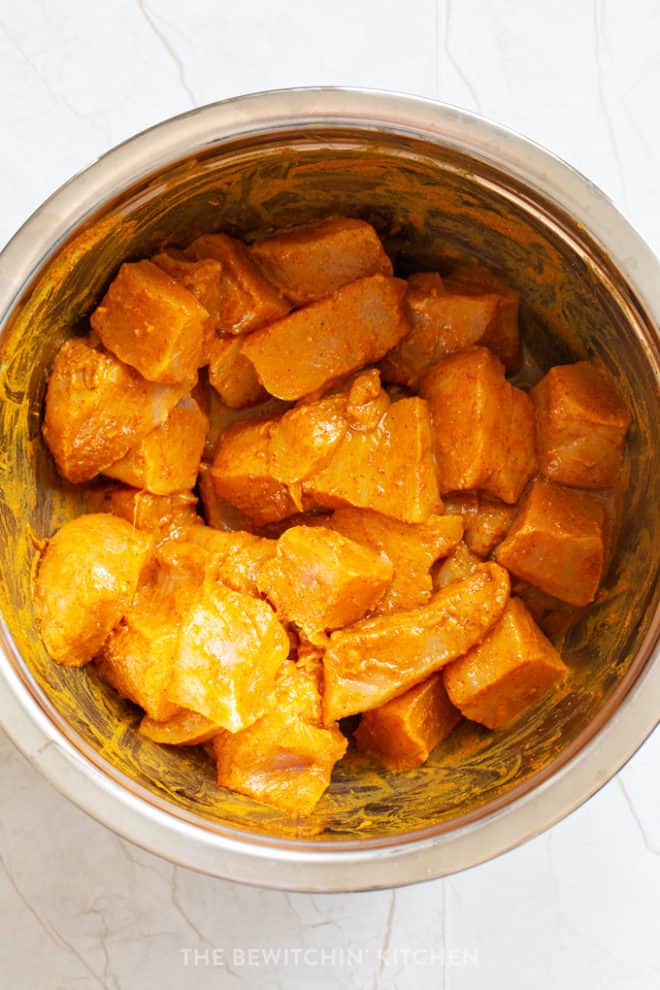 cubed chicken in a curry marinade