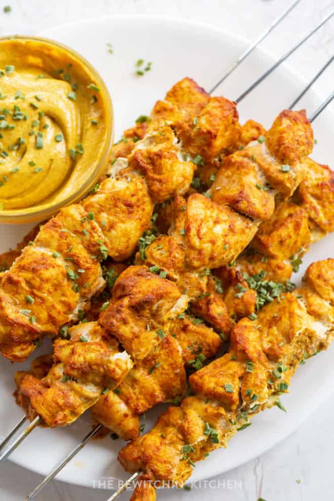 Chicken kebabs on a stainless steel skewer flavored with curry