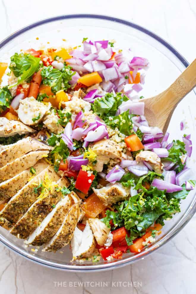 healthy chicken summer salad with red onions, kale, quinoa, and sundried tomatoes