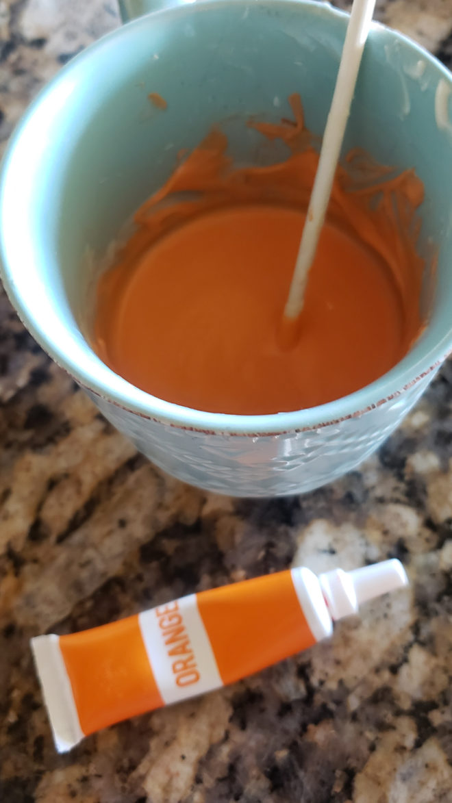 Melted chocolate with food coloring in a cup