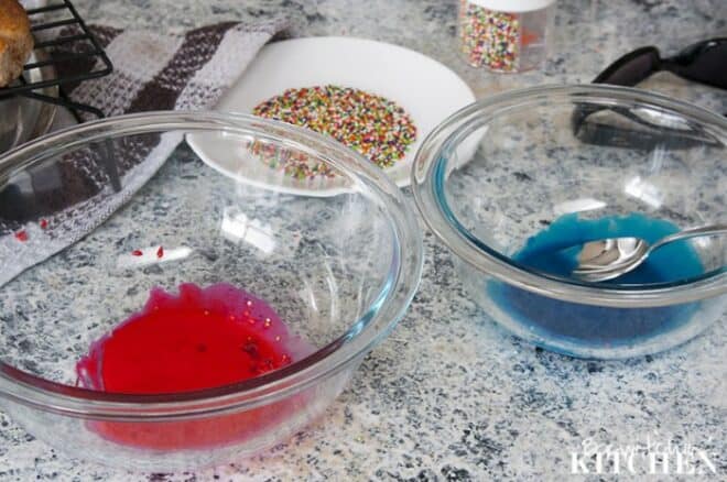 separate bowls containing red glaze, blue glaze, and sprinkles