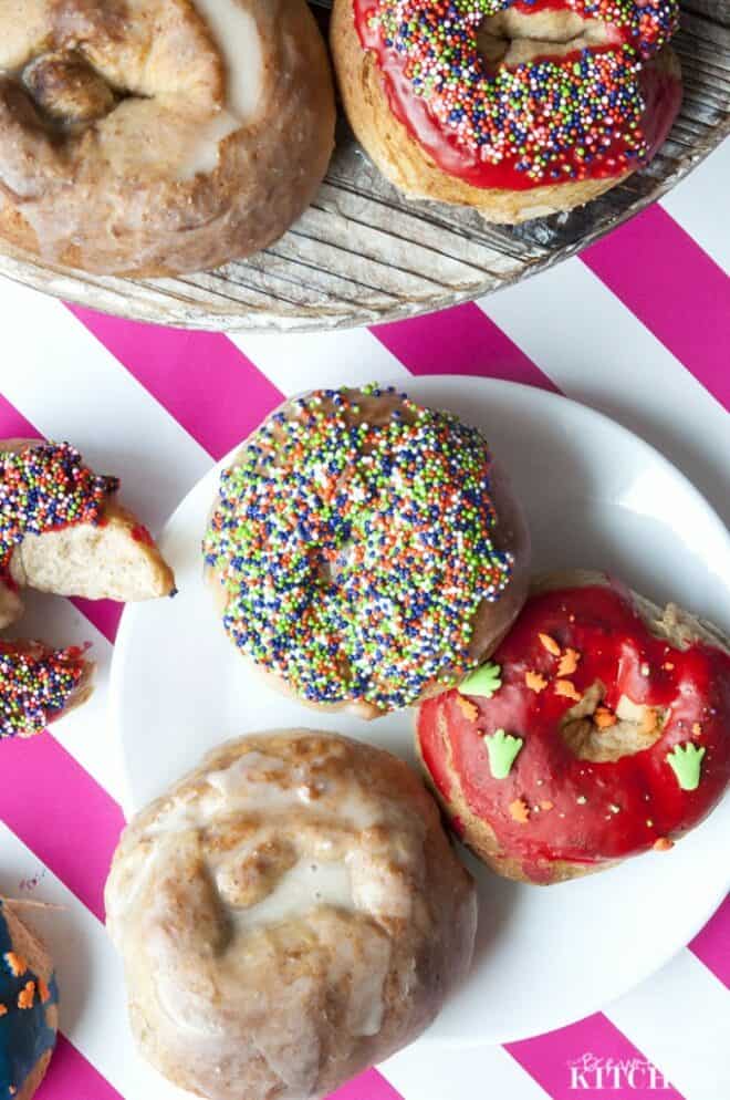overhead of cake donuts topped with glaze and sprinkles