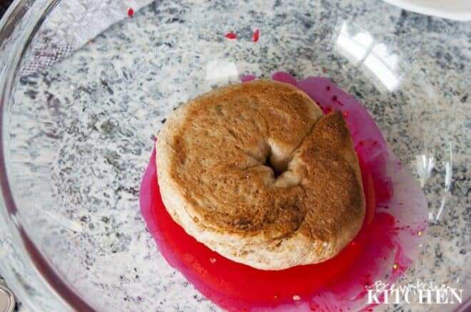 homemade baked donut in a bowl of glaze