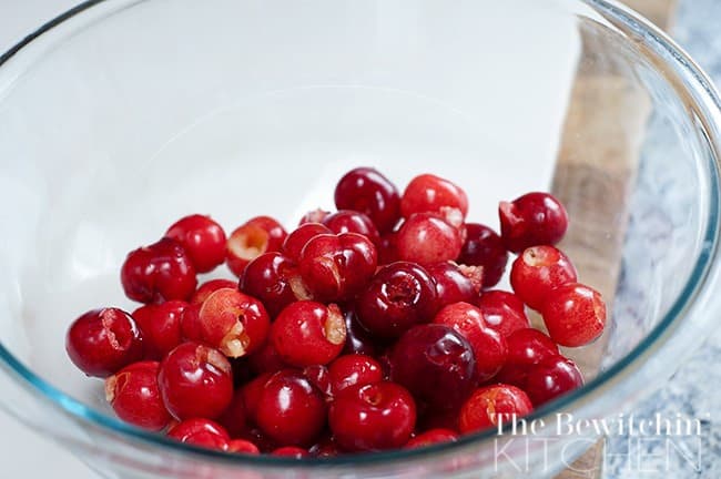 washed and pitted cherries in a glass bowl