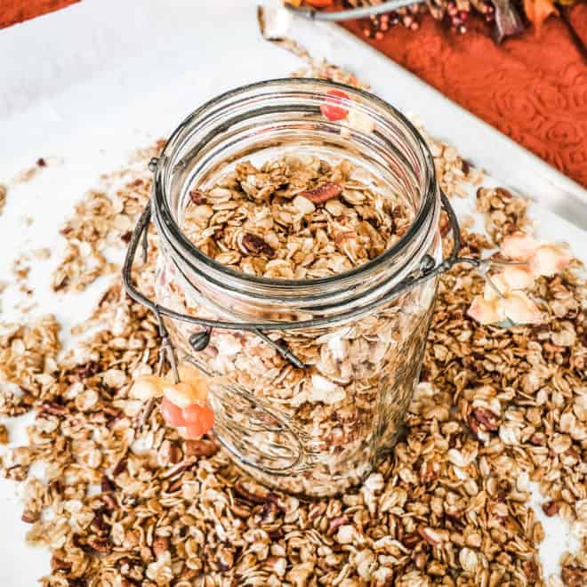 maple pecan granola in and around an open mason jar