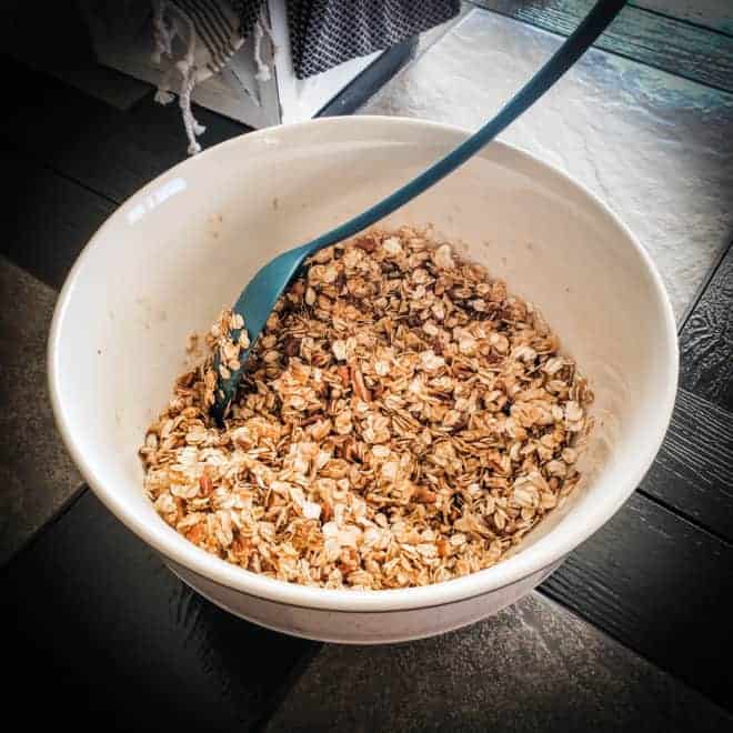 mixing pumpkin granola in a large bowl