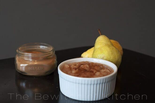 ramekin of pear butter surrounded by cinnamon and fresh pears