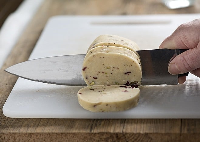 slicing cranberry pistachio cookie dough
