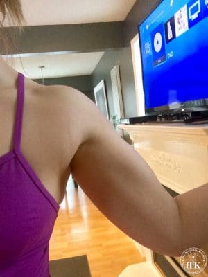 A toned, flexing arm showing off Insanity workout results