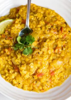 spoon in a bowl of coconut lentil curry soup