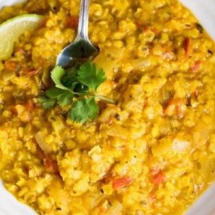 spoon in a bowl of coconut lentil curry soup