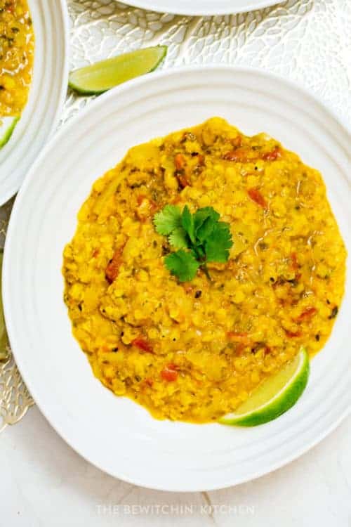 overhead of coconut lentil soup with lime and cilantro garnish