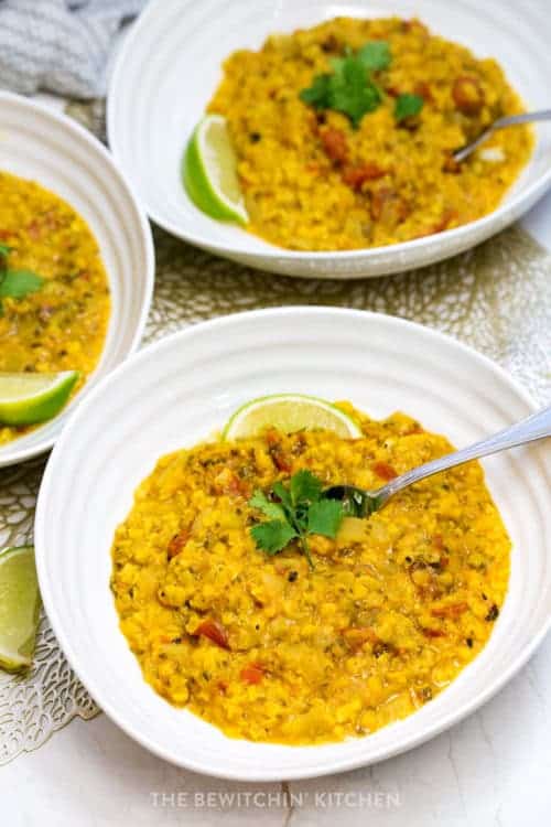 three bowls of lentil curry soup topped with cilantro