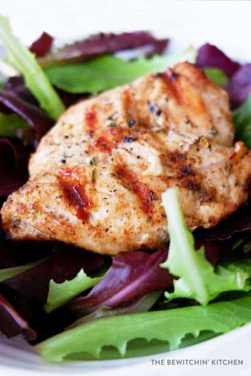 close up of a garlic lime chicken breast on a chili lime chicken salad
