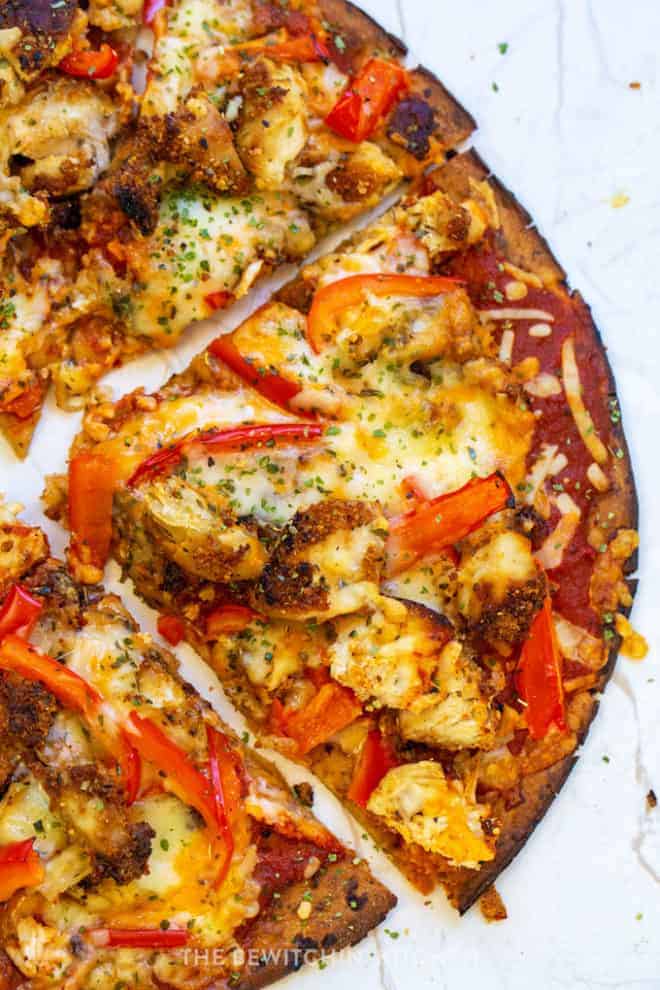 closeup up parmesan pizza with chicken and cauliflower crust