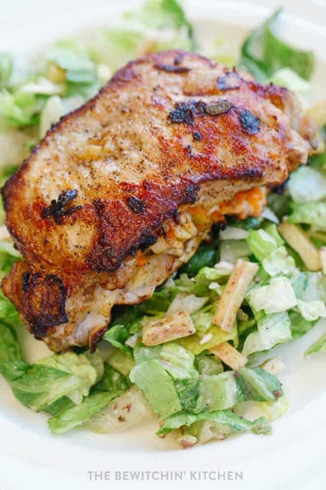 apple stuffed pork chops on a bed of lettuce