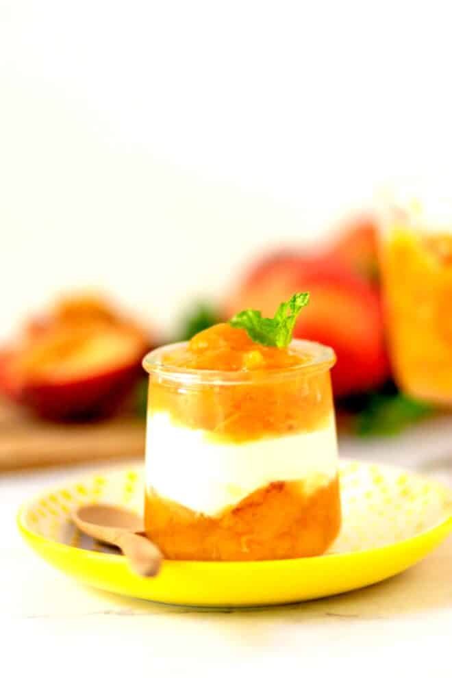 Peach compote in a glass with ginger