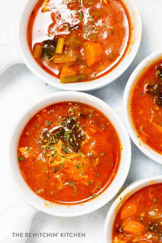 Top view of several bowls of chicken and vegetable soup