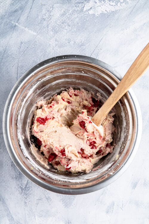 Mixing the ingredients for white chocolate raspberry cookies. 