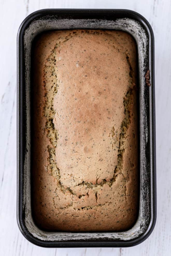 Baked lemon poppy seed pound cake in a loaf pan.