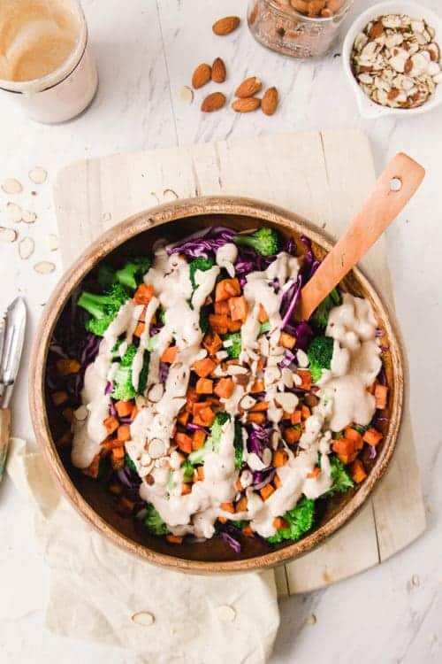 Top view of a sweet potato broccoli bowl with dressing