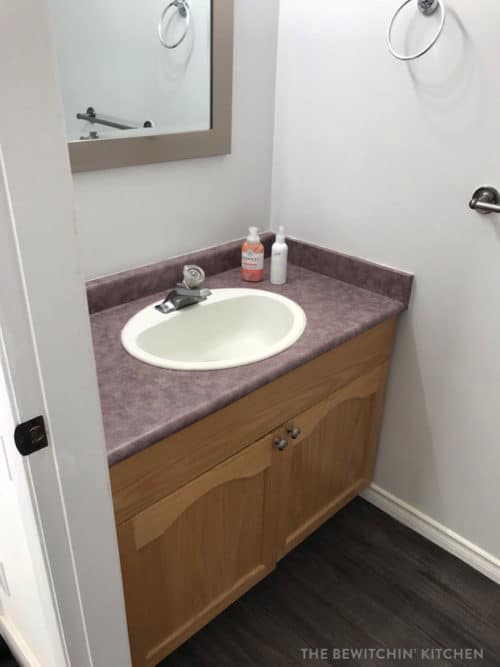 Bathroom vanity before a budget small bathroom remodel