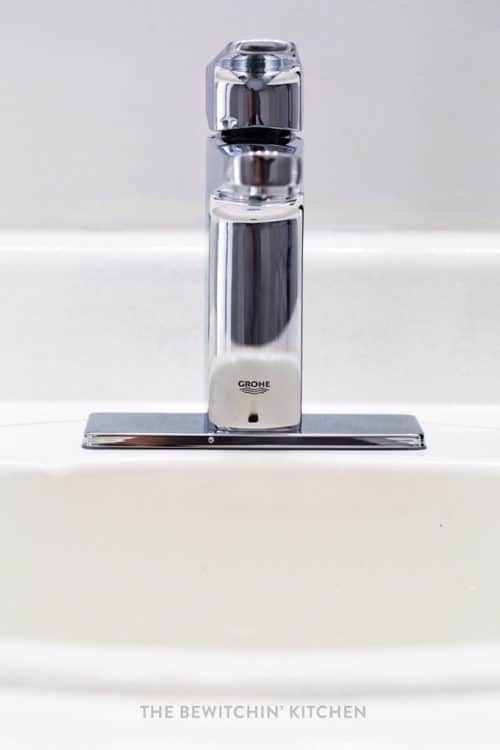 Front view of a new faucet used in a budget small bathroom remodel