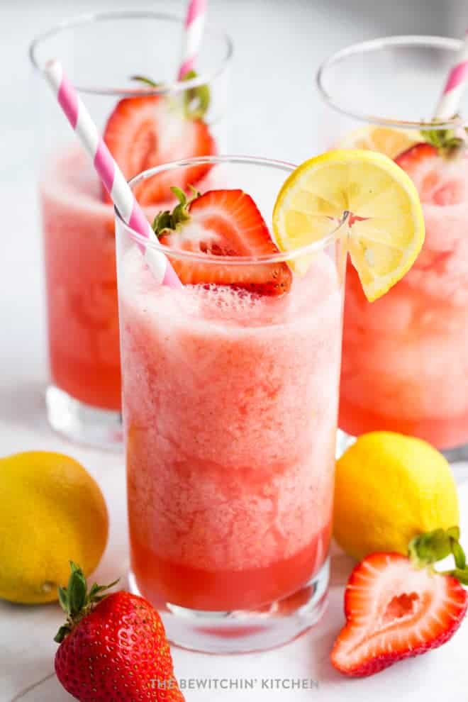 strawberry lemonade garnished with strawberries and lemons