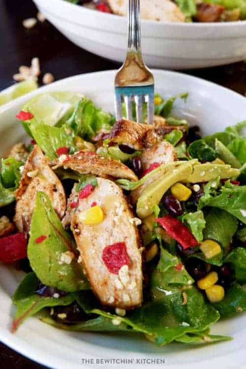 Santa Fe chicken salad in a white bowl with a silver fork.