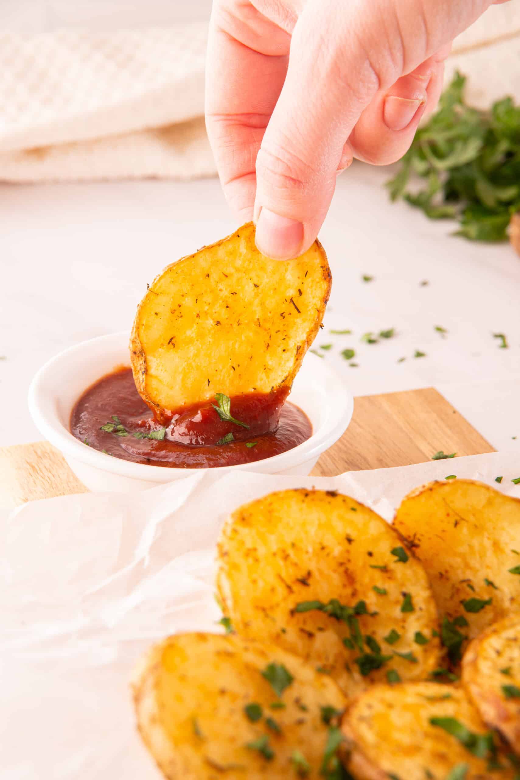 Dipping Cottage fries in ketchup