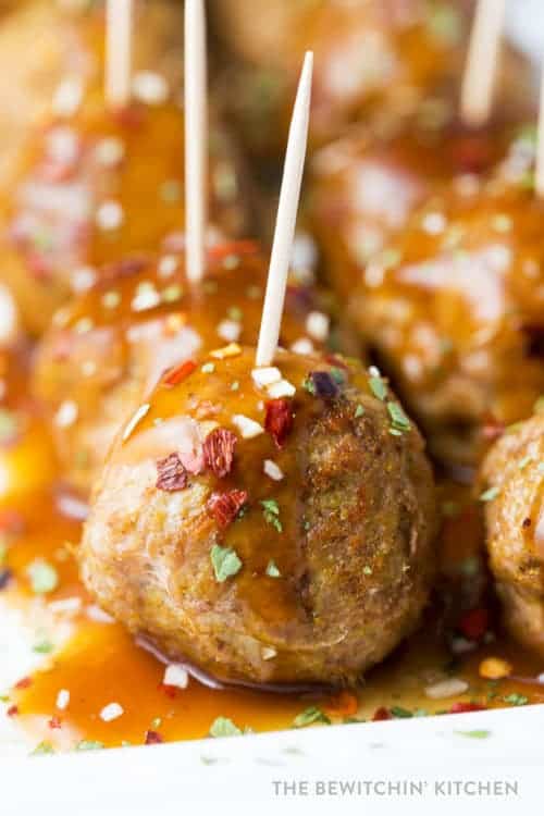 spicy chicken meatballs with serving toothpicks on a serving platter for a delicious curry appetizer