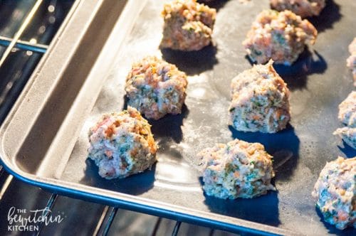 Uncooked chicken meatballs in oven 