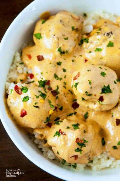 Top view of a bowl of coconut curry meatballs over cauliflower rice.