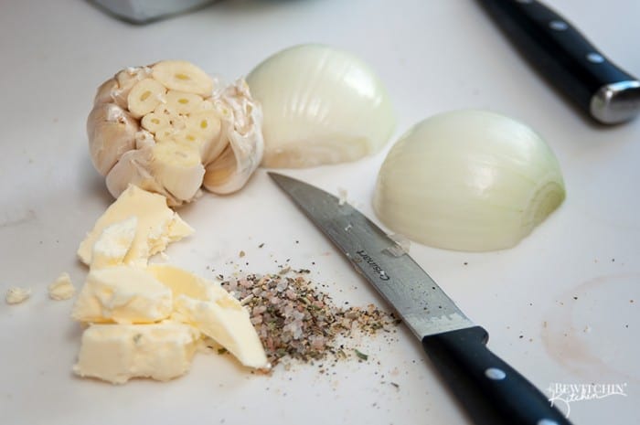 close up of sliced onion, garlic, butter, and spices needed for cooking a turkey