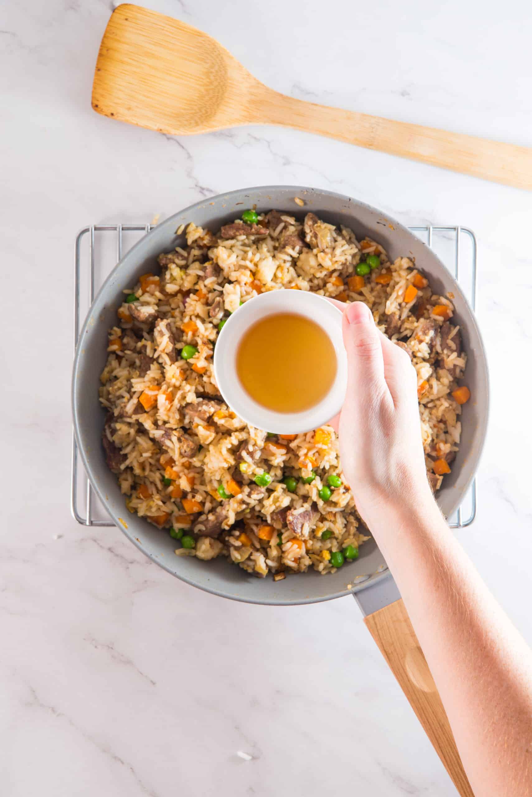 Cooking fried Rice in a pan with sauce