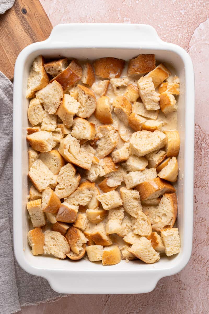 {ices of bread in a baking dish with custard sauce