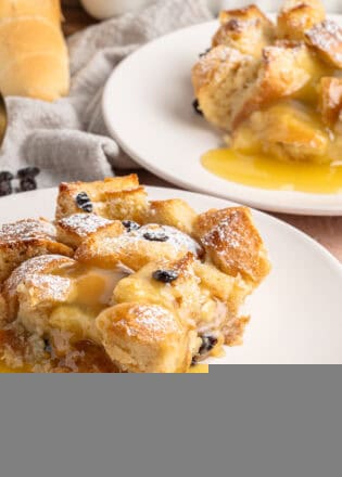 Two servings of bread pudding with rum sauce
